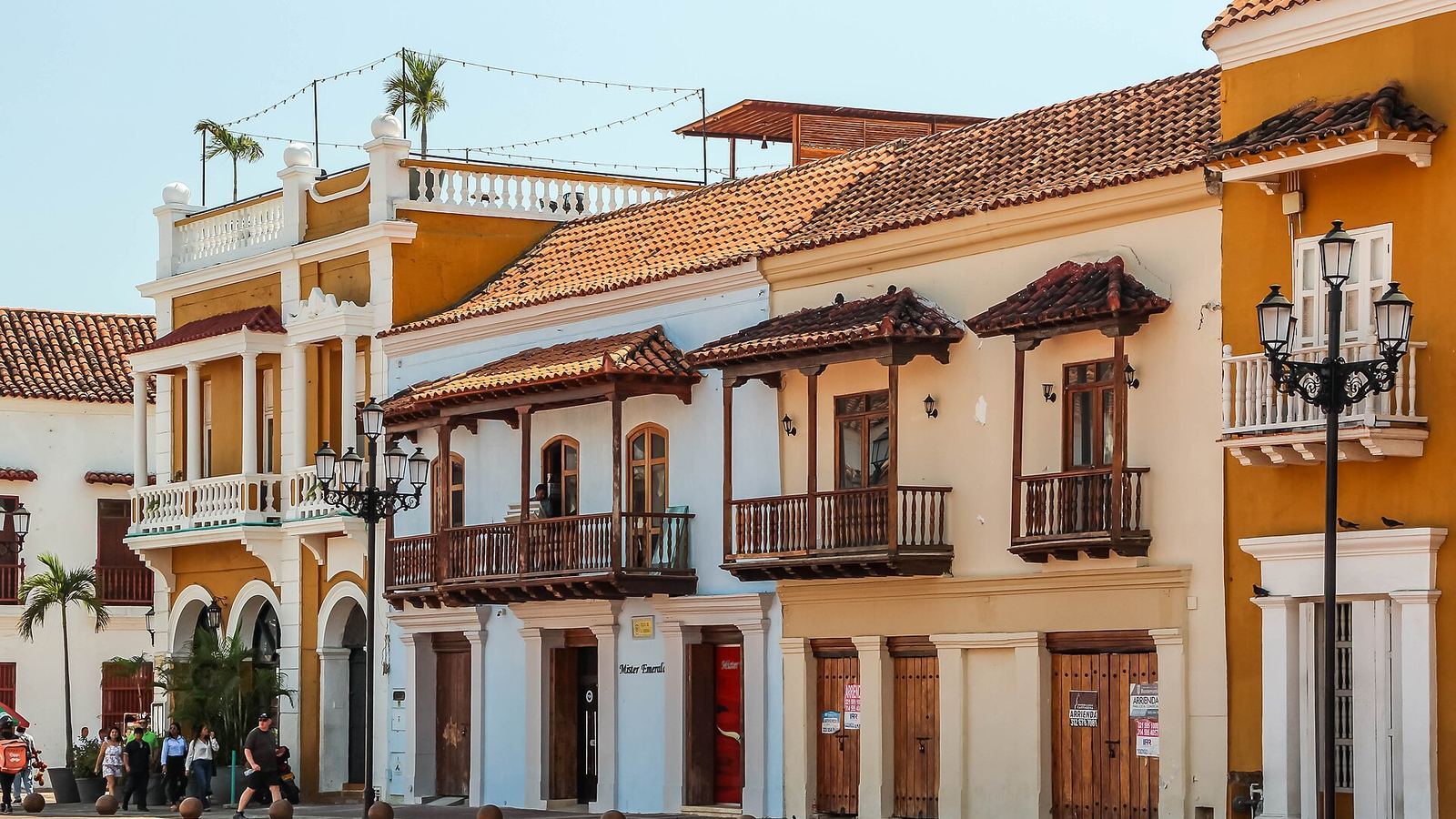 Colonial façades with wooden balconies on Plaza de la Aduana in Cartagena's walled old town