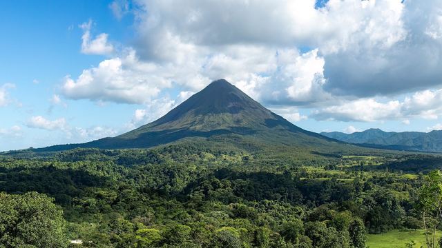 The cone of Arenal volcano above the rainforest