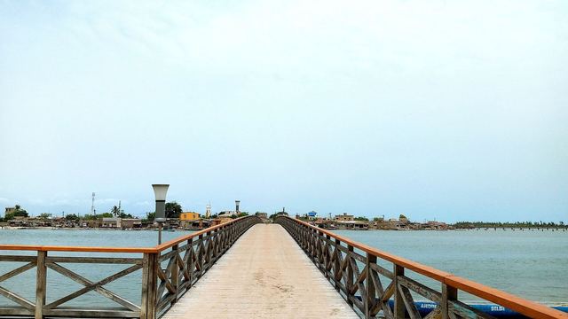 De lange houten brug naar het schelpeneiland Fadiouth