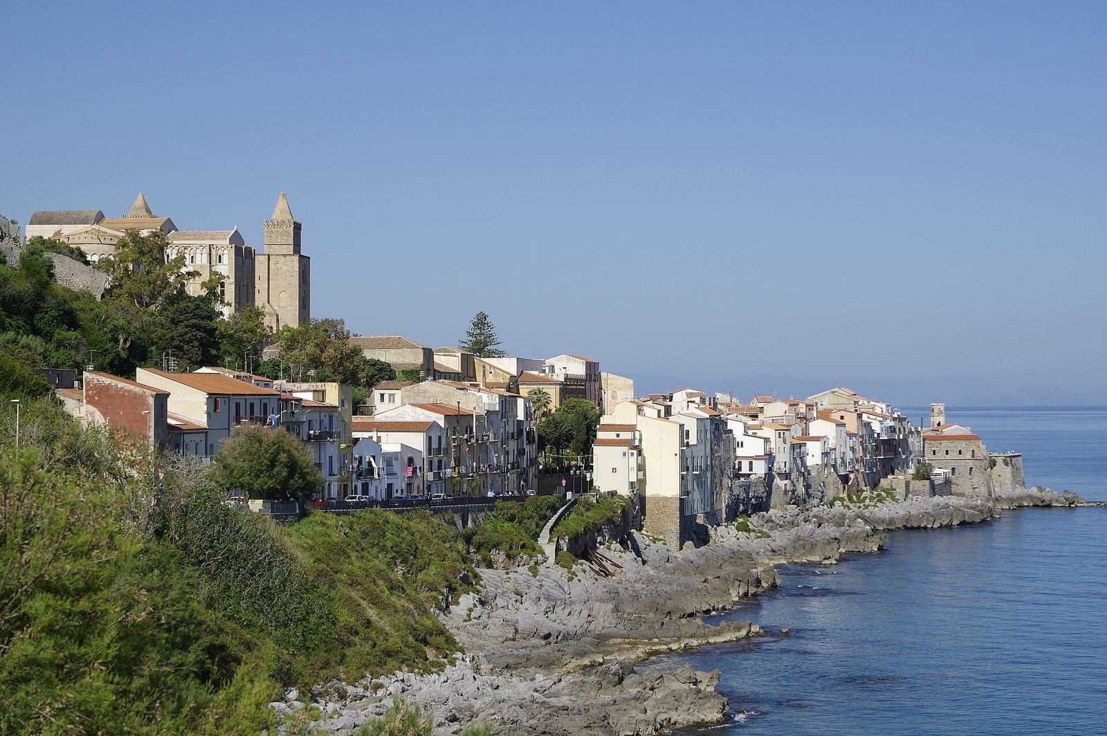 The old town of Cefalù with the cathedral above the sea